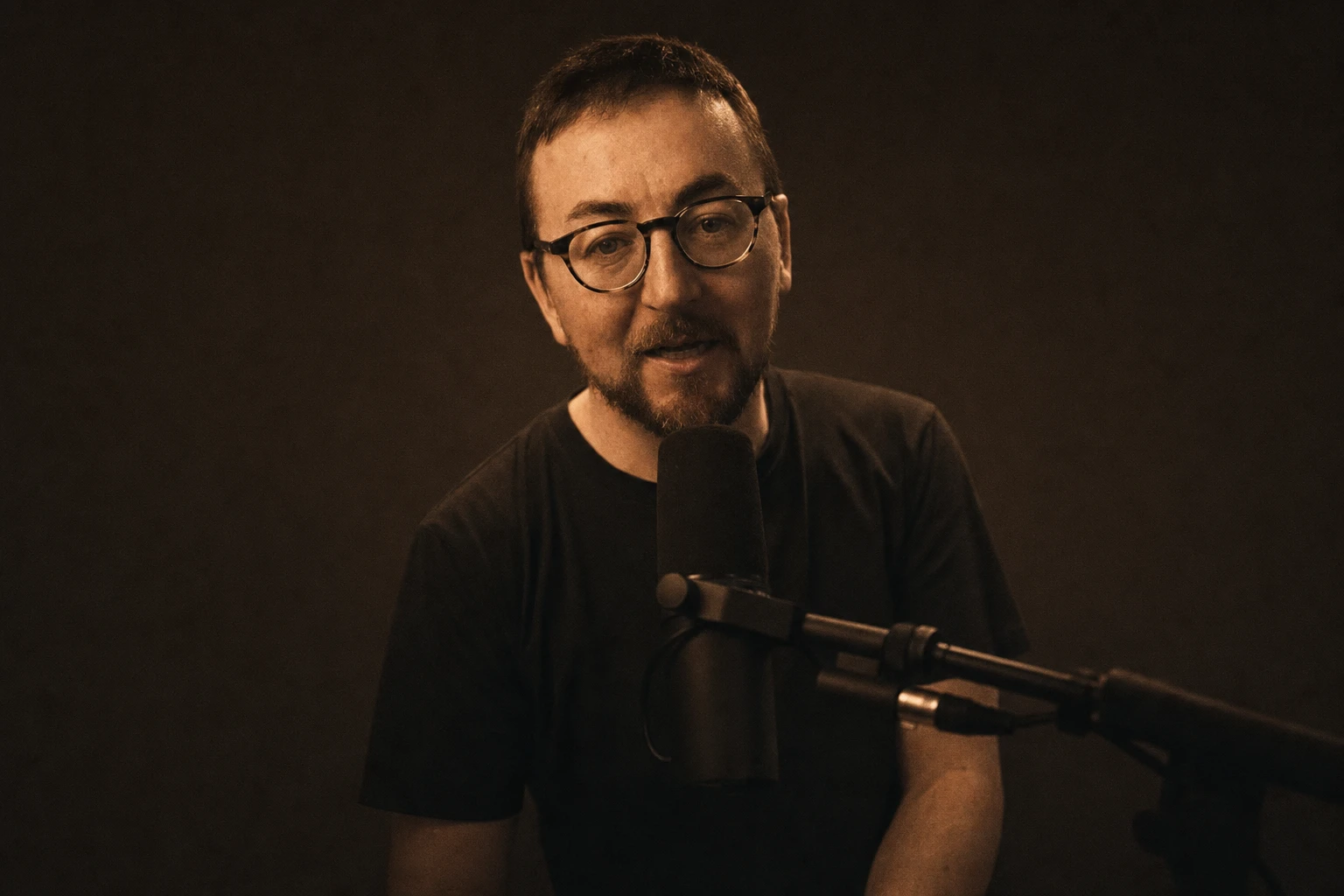 Copper-toned portrait of Gareth at his microphone