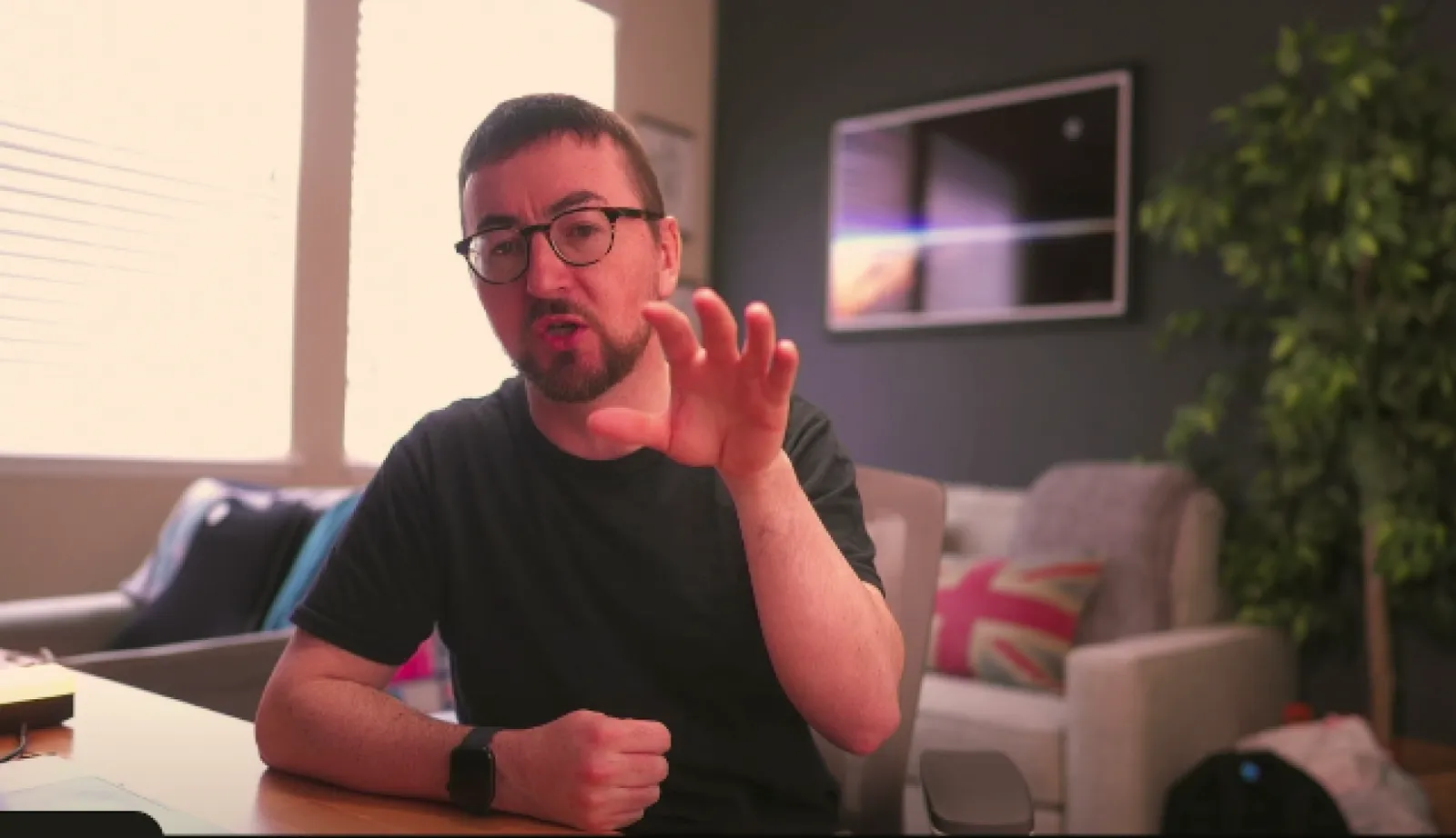Gareth at his desk, talking to the camera